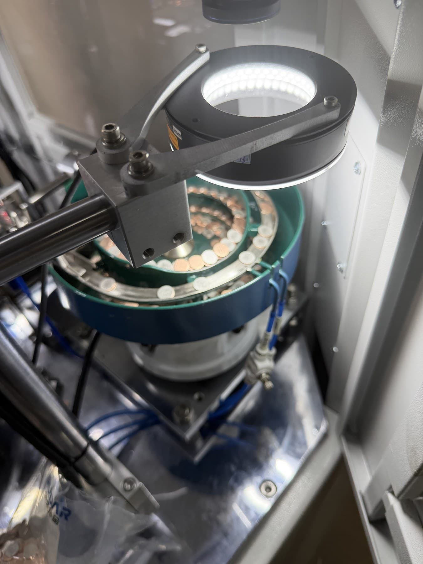 Automated sorting process for electrical contact components in the workshop.